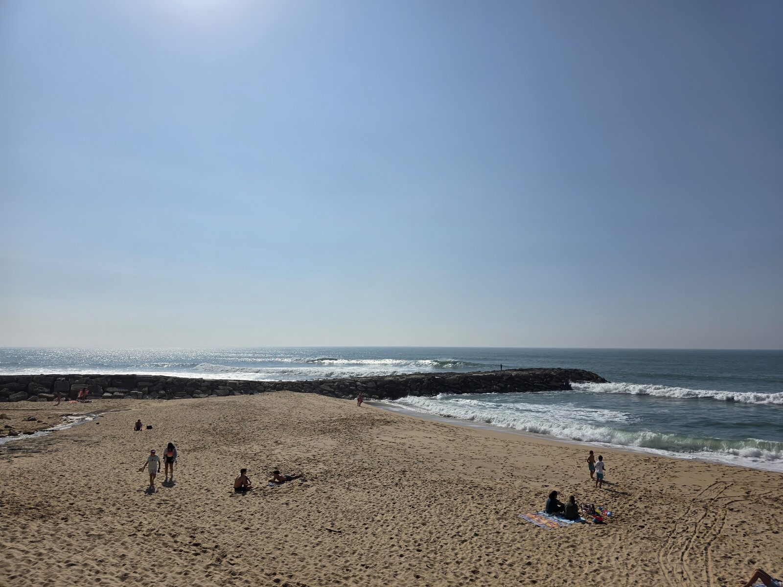 Ericeira beach with surfers on a sunny day