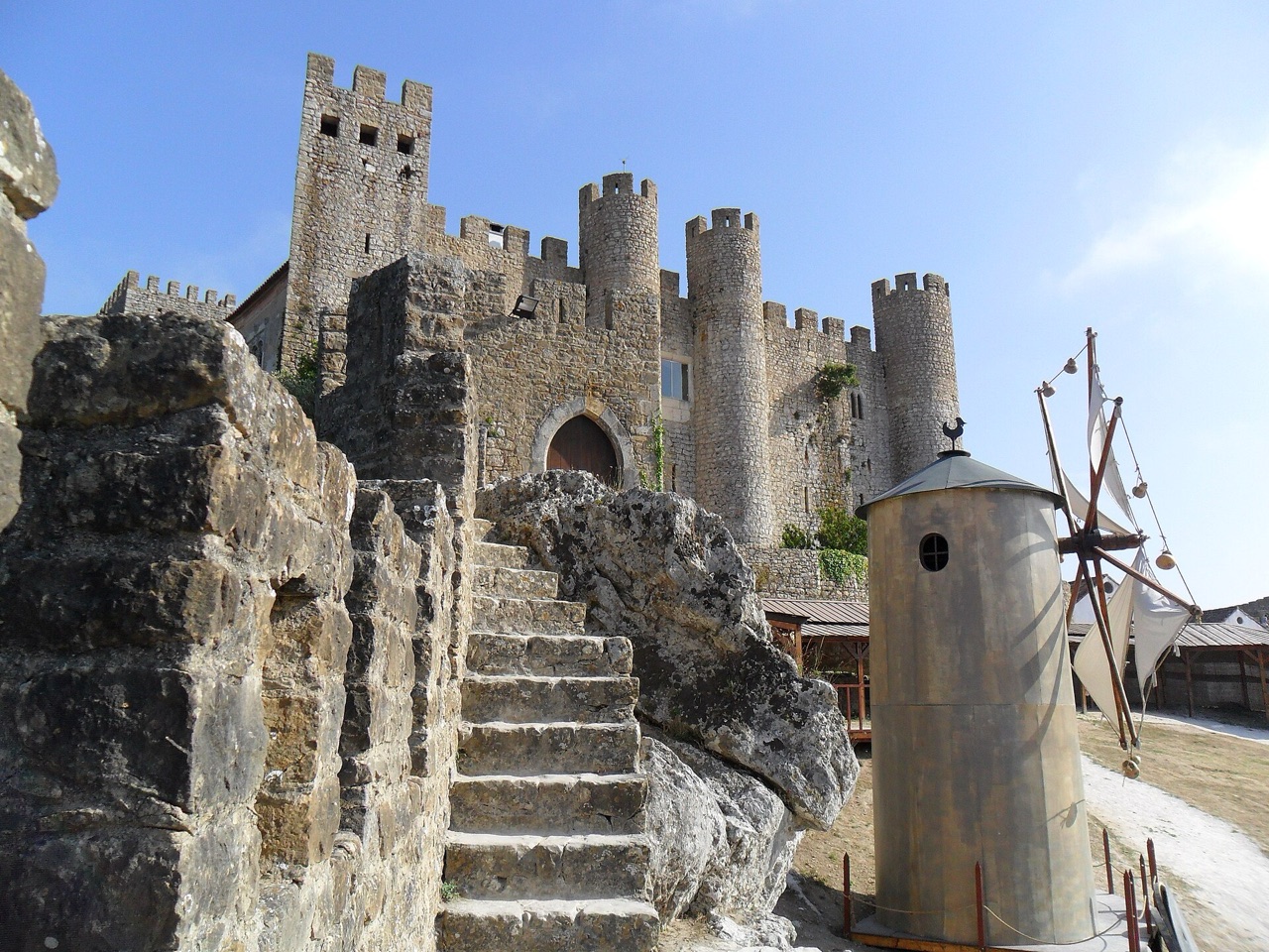 Óbidos castle keep and stone towers against a bright blue sky