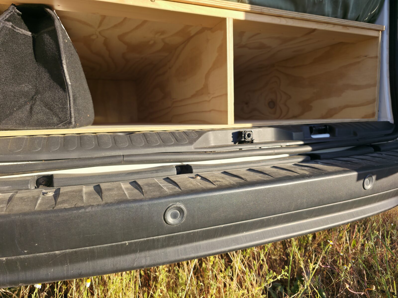 Built-in plywood storage drawers beneath the bed platform